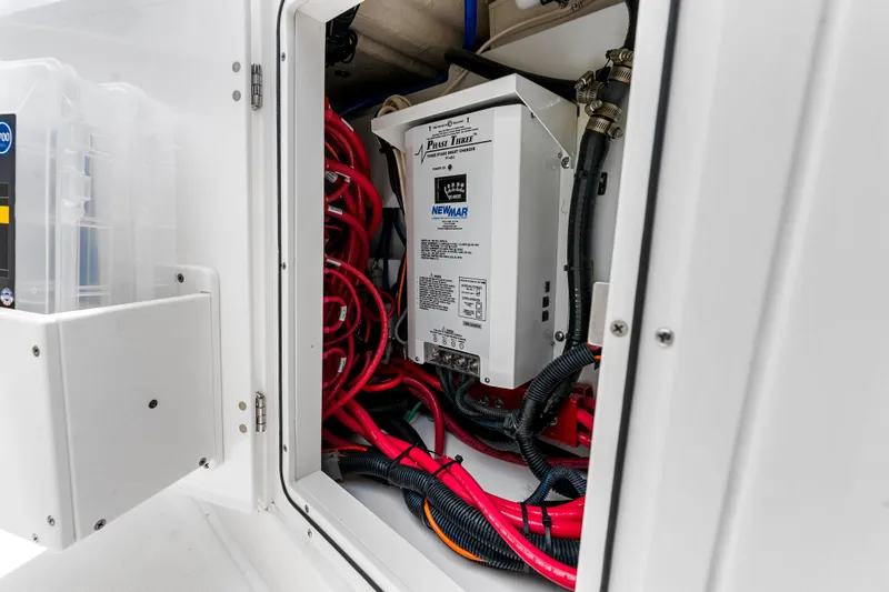 Slide: The Image of Electrical compartment of 2025 Pursuit S 328 Sport boat with wiring and charger. - 47