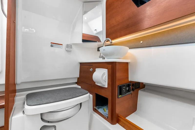 Slide: The Image of 2025 Pursuit S 328 Sport boat bathroom with modern sink and wooden cabinetry. - 38