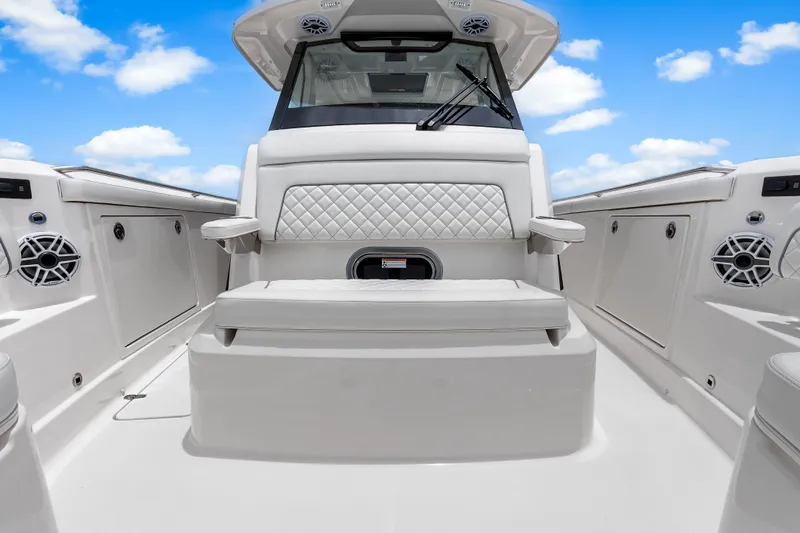 Slide: The Image of 2025 Pursuit S 328 Sport boat interior with cushioned seating and sleek design. - 13