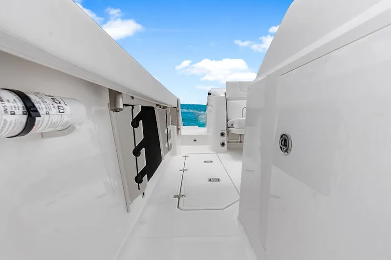 Slide: The Image of 2025 Pursuit S 328 Sport boat deck with ocean view, showcasing sleek design and white finish. - 19
