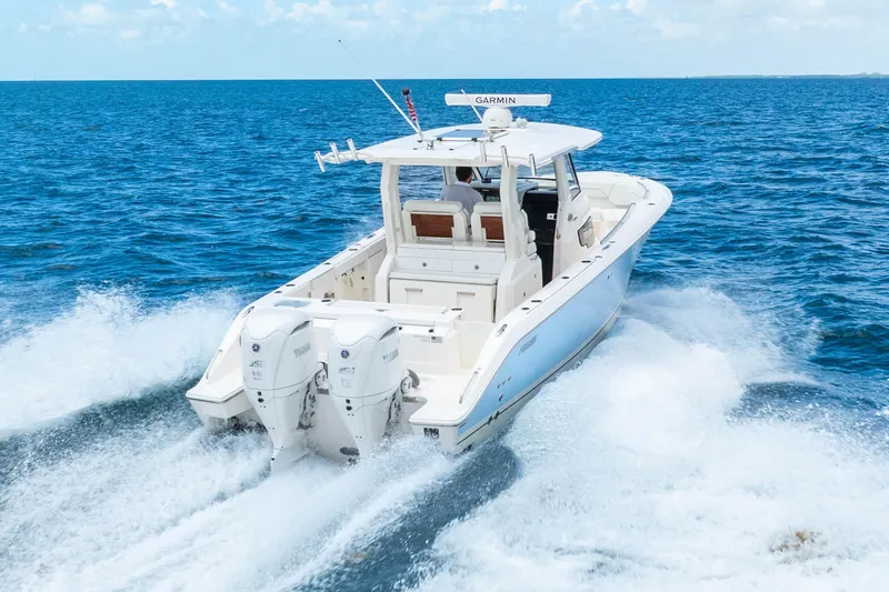 Slide: The Image of 2025 Pursuit S 328 Sport boat cruising on open blue ocean waters. - 10