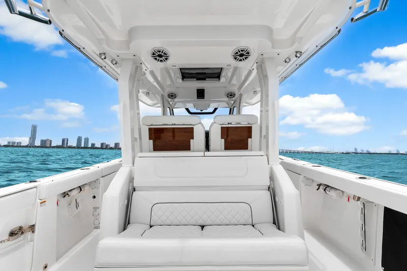 Slide: The Image of 2025 Pursuit S 328 Sport boat interior with ocean view and city skyline. - 25