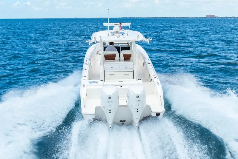Slide: The Image of 2025 Pursuit S 328 Sport boat cruising on open ocean waters. - 9