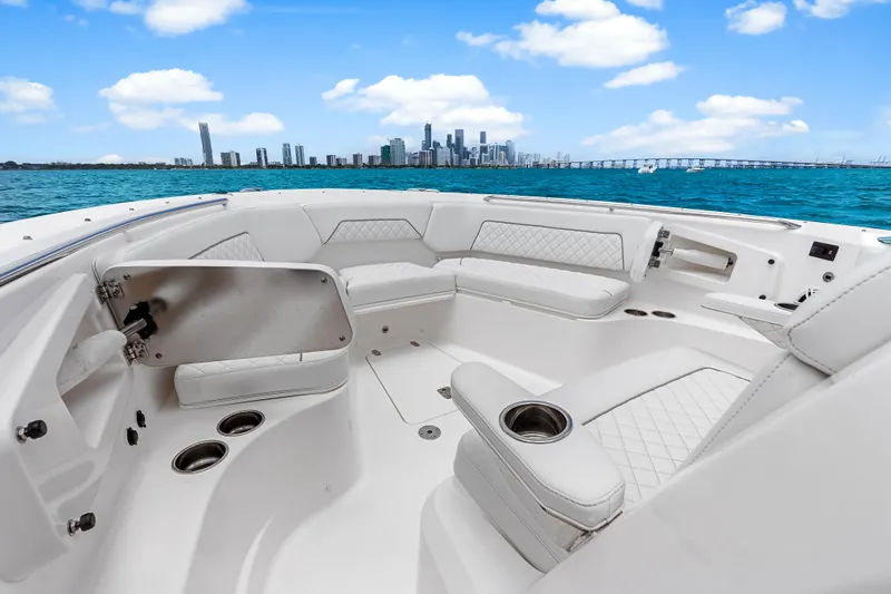 Slide: The Image of 2025 Pursuit S 328 Sport boat interior with city skyline and ocean view. - 14