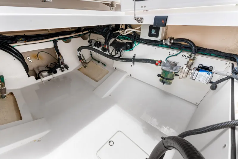 Slide: The Image of 2025 Pursuit S 328 Sport boat interior showing clean engine compartment and wiring. - 45