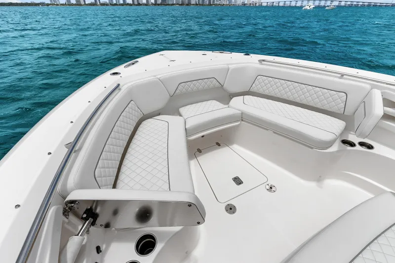 Slide: The Image of Luxurious seating on 2025 Pursuit S 328 Sport boat, with ocean view and city skyline. - 15