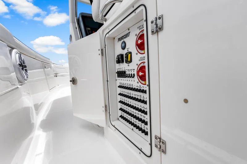 Slide: The Image of 2025 Pursuit S 328 Sport boat electrical panel with open access door. - 29
