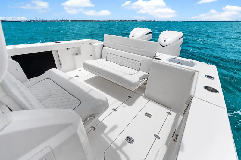 Slide: The Image of 2025 Pursuit S 328 Sport boat interior with luxurious seating on open water. - 32