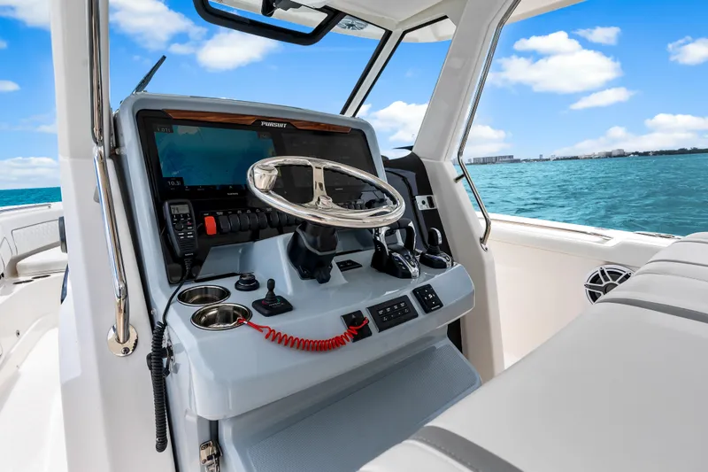 Slide: The Image of 2025 Pursuit S 328 Sport boat helm with modern controls and ocean view. - 23