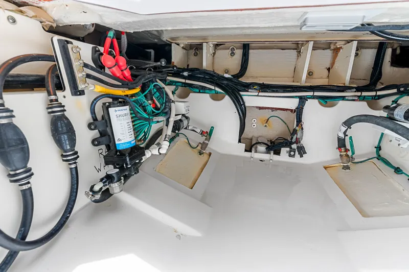 Slide: The Image of Interior view of 2025 Pursuit S 328 Sport boat's wiring and plumbing system. - 46