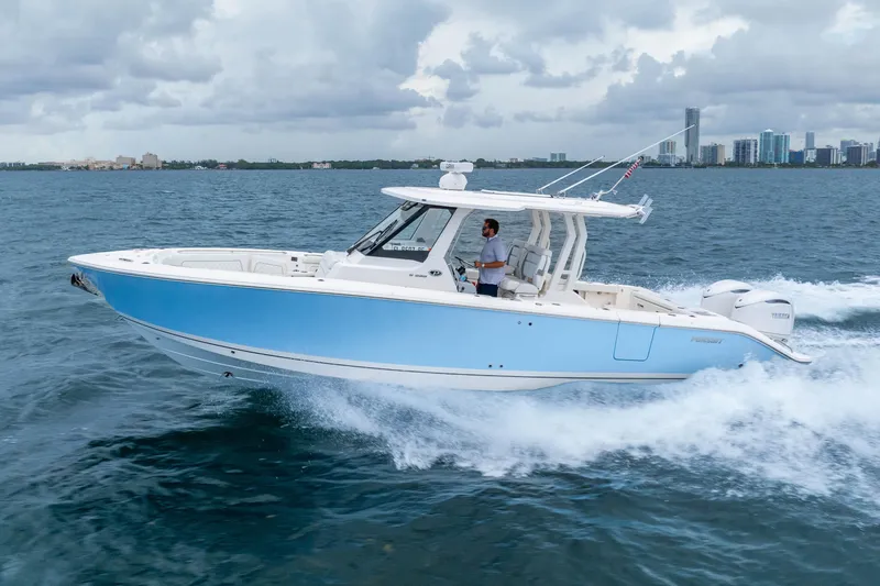 The Image of 2025 Pursuit S 328 Sport boat cruising on open water under cloudy skies. - 0