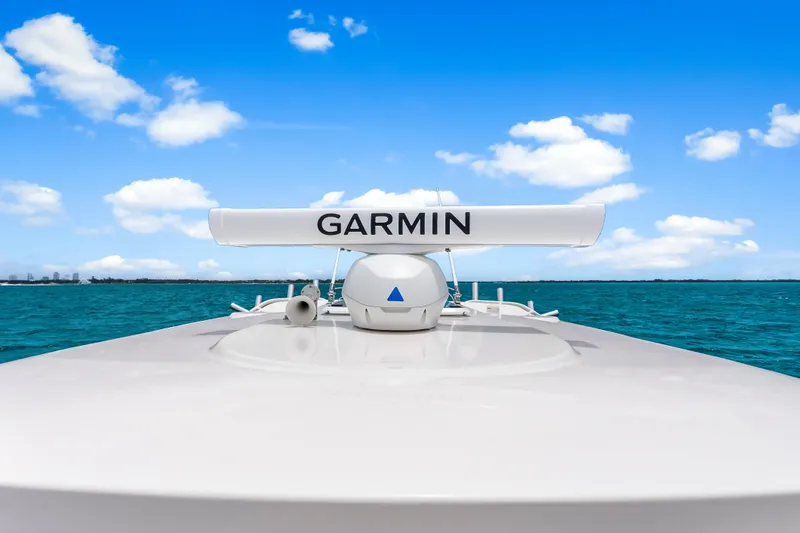 Slide: The Image of 2025 Pursuit S 328 Sport boat with Garmin radar on open sea under blue sky. - 44