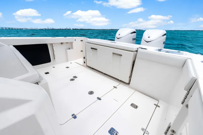 Slide: The Image of 2025 Pursuit S 328 Sport boat deck with twin engines on a sunny day. - 30