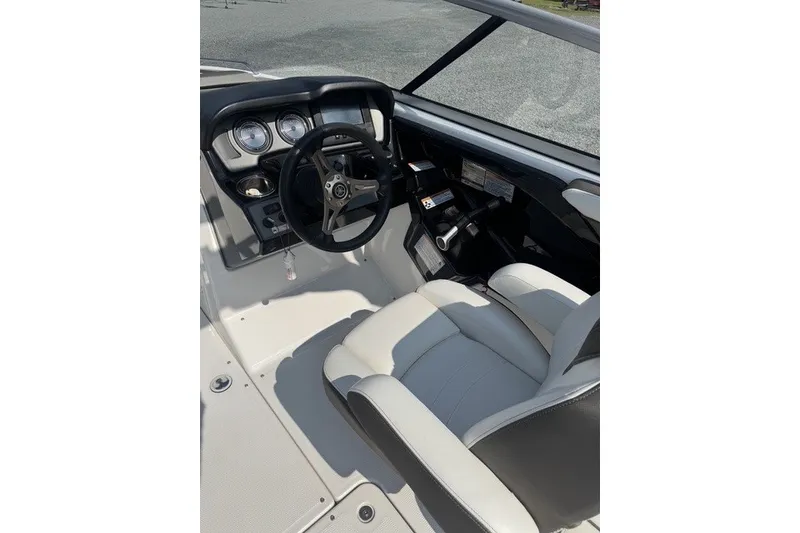 Slide: The Image of 2015 Yamaha Boats 242 Limited S cockpit with steering wheel and dashboard controls. - 6