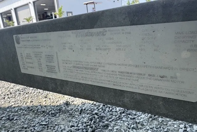 Slide: The Image of Label on a 2015 Yamaha Boats 242 Limited S, displayed outdoors on gravel. - 12