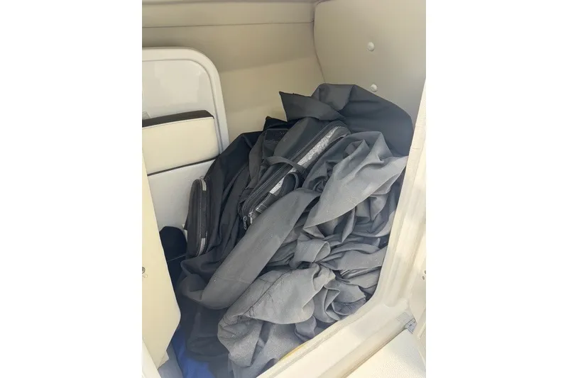 Slide: The Image of Storage compartment of a 2015 Yamaha Boats 242 Limited S with black fabric inside. - 10