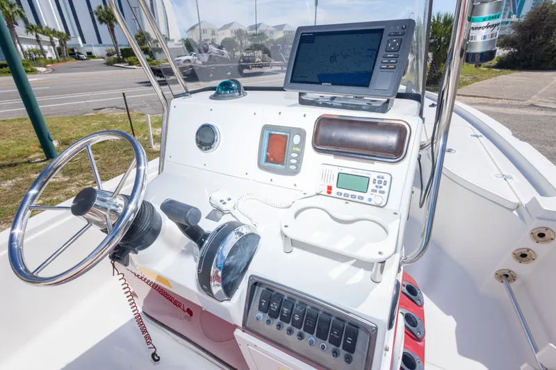 Slide: The Image of 2003 Triton 220 LTS boat console with steering wheel and navigation equipment. - 47