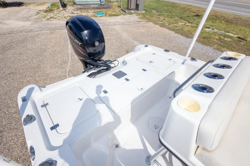 Slide: The Image of 2003 Triton 220 LTS boat with Mercury outboard motor, featuring spacious deck layout. - 41