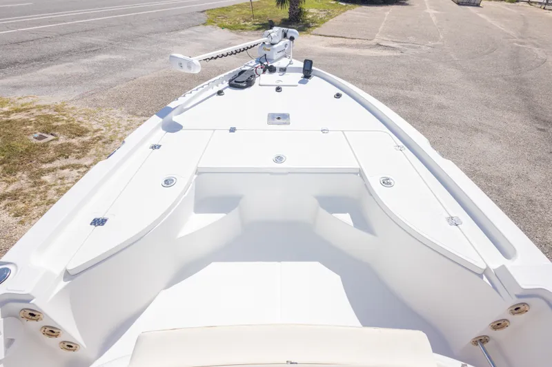 Slide: The Image of 2003 Triton 220 LTS boat deck, white finish, parked on pavement. - 30