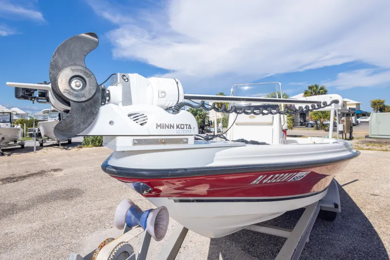 Slide: The Image of 2003 Triton 220 LTS boat with Minn Kota Ulterra motor, parked outdoors. - 18