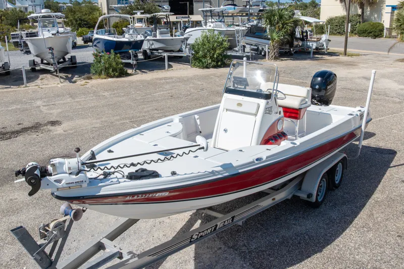 Slide: The Image of 2003 Triton 220 LTS boat on trailer, featuring Minn Kota trolling motor. - 4