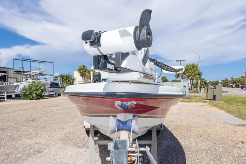 Slide: The Image of 2003 Triton 220 LTS boat with trolling motor, parked outdoors under a clear sky. - 20