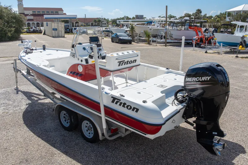 Slide: The Image of 2003 Triton 220 LTS boat with Mercury outboard motor on trailer in marina. - 52