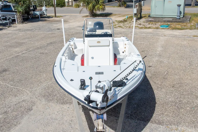 Slide: The Image of 2003 Triton 220 LTS boat on trailer, parked outdoors, showcasing bow and trolling motor. - 5