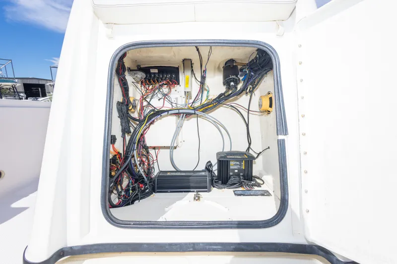 Slide: The Image of Electrical wiring and components inside a 2003 Triton 220 LTS boat compartment. - 35