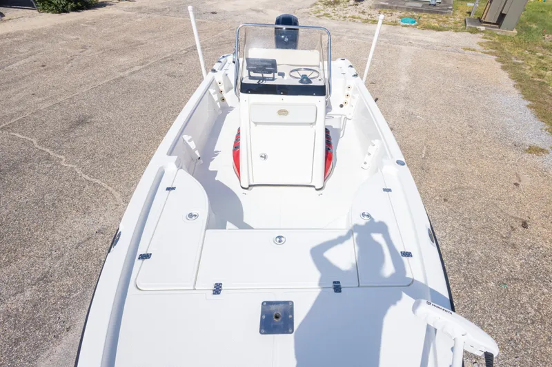 Slide: The Image of 2003 Triton 220 LTS boat interior with steering console and storage compartments. - 36