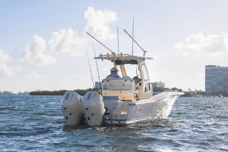 Slide: The Image of A 2027 Scout 260 LXF boat on the water with two outboard engines. - 11
