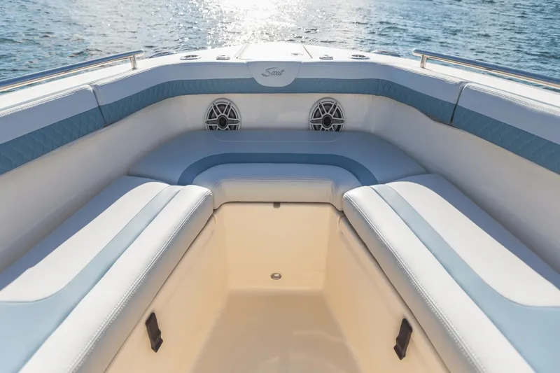 Slide: The Image of The image shows the bow area of a Scout 260 LXF boat with blue and white upholstery. - 19
