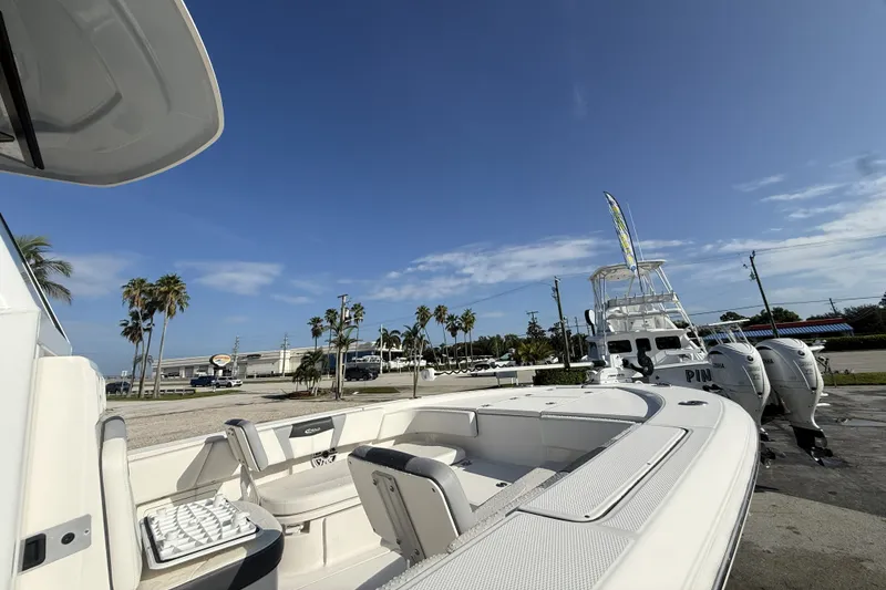 Slide: The Image of 2023 Robalo 266 Cayman boat docked under clear blue sky. - 13