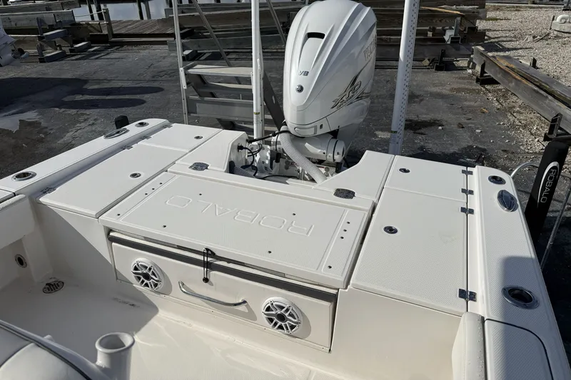 Slide: The Image of 2023 Robalo 266 Cayman boat with Yamaha engine, docked at marina. - 21