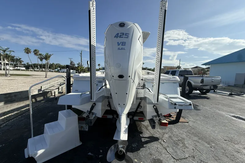 Slide: The Image of 2023 Robalo 266 Cayman boat with 425 V8 engine, parked outdoors. - 12