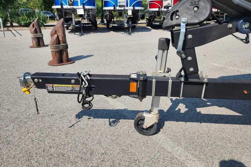 Slide: The Image of Trailer hitch of a 2018 Crestliner PT 20 boat, parked on asphalt. - 2