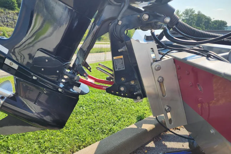 Slide: The Image of 2018 Crestliner PT 20 boat motor mount and propeller detail in a grassy outdoor setting. - 10