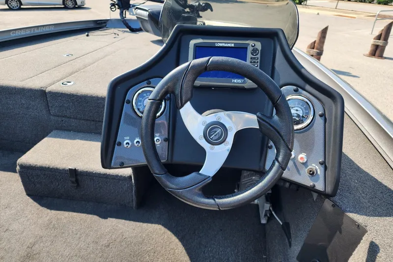 Slide: The Image of 2018 Crestliner PT 20 boat dashboard with steering wheel and Lowrance HD57 display. - 4