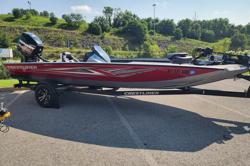 The Image of 2018 Crestliner PT 20 boat with Mercury engine on trailer, parked outdoors. - 0