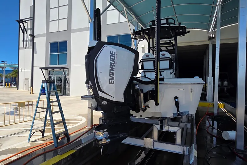 Slide: The Image of 2016 Ranger 2510 Bay Ranger boat with Evinrude engine in a marina setting. - 56