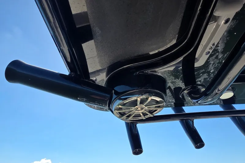 Slide: The Image of 2016 Ranger 2510 Bay Ranger boat underside with speaker and rod holders against blue sky. - 36
