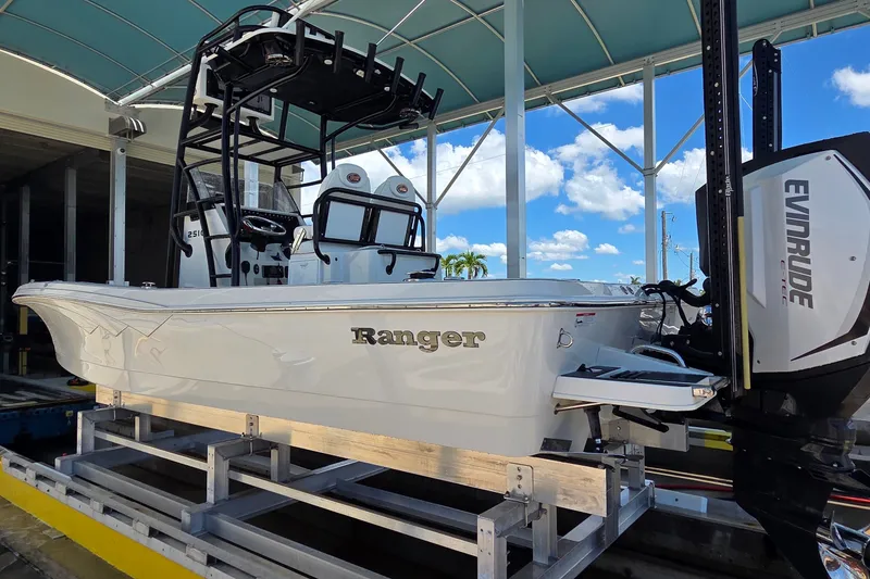 Slide: The Image of 2016 Ranger 2510 Bay Ranger boat with Evinrude engine under a canopy. - 61