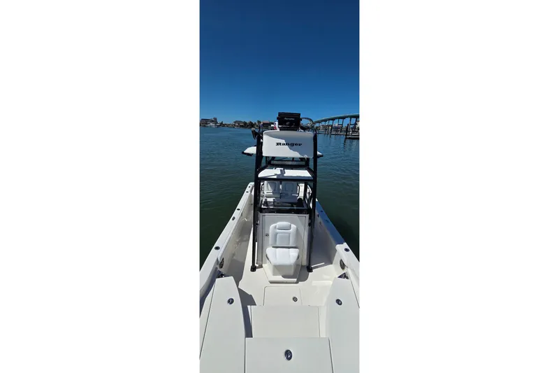 Slide: The Image of 2016 Ranger 2510 Bay Ranger boat on calm water, clear sky background. - 47