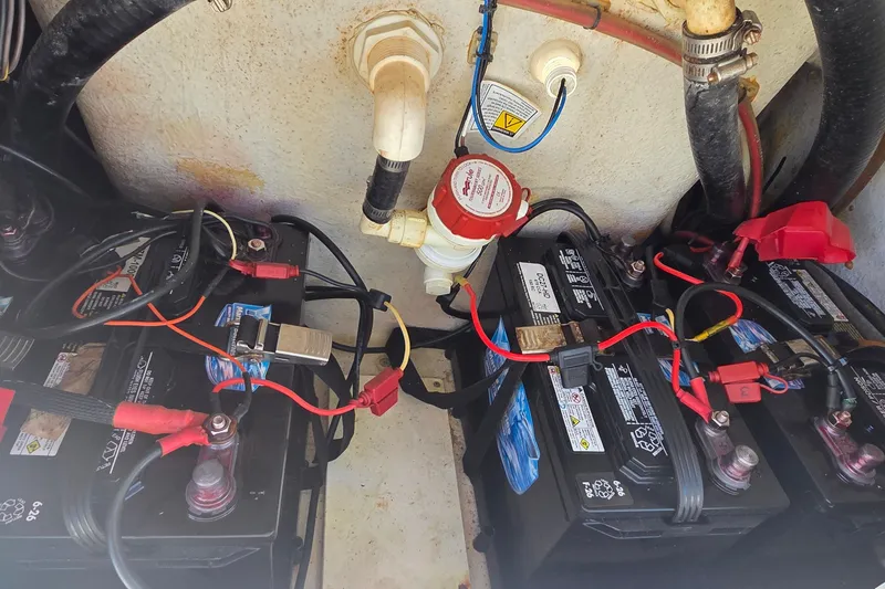 Slide: The Image of 2016 Ranger 2510 Bay Ranger boat battery compartment with wiring and connections. - 21