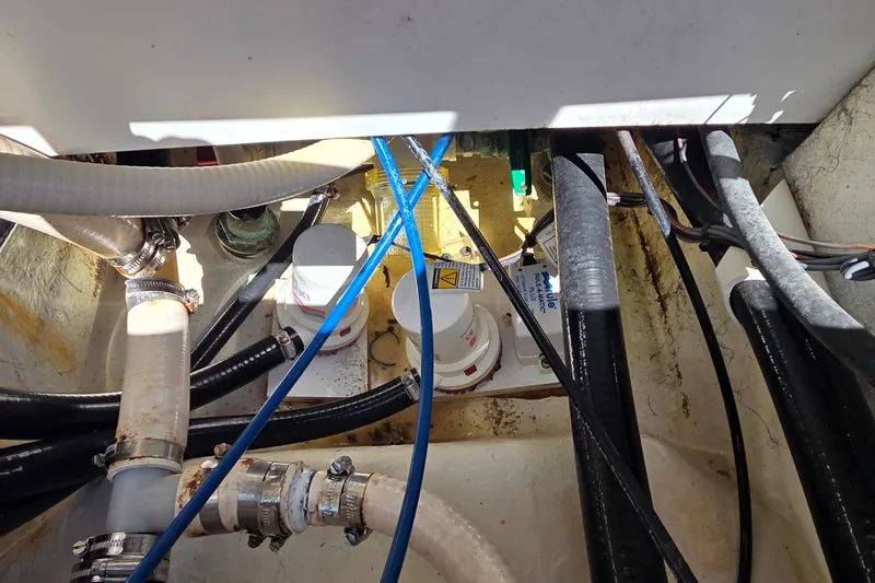 Slide: The Image of 2016 Ranger 2510 Bay Ranger boat bilge area with hoses and pumps. - 17