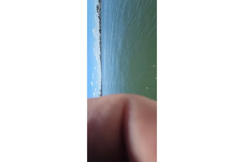 Slide: The Image of A 2016 Ranger 2510 Bay Ranger on calm waters with a clear blue sky. - 49