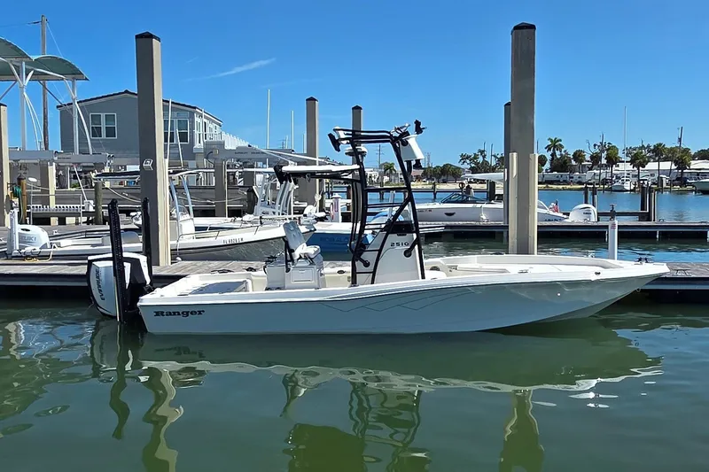 Slide: The Image of 2016 Ranger 2510 Bay Ranger boat docked at marina under clear blue sky. - 3