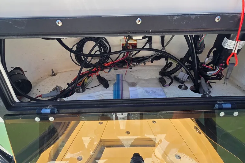 Slide: The Image of 2016 Ranger 2510 Bay Ranger boat wiring compartment with cables and components visible. - 40