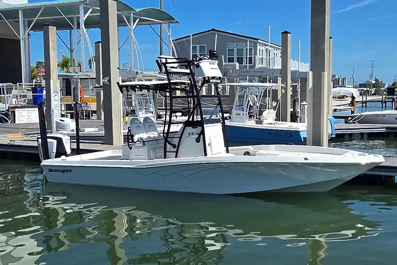 Slide: The Image of 2016 Ranger 2510 Bay Ranger boat docked at marina under clear blue sky. - 4
