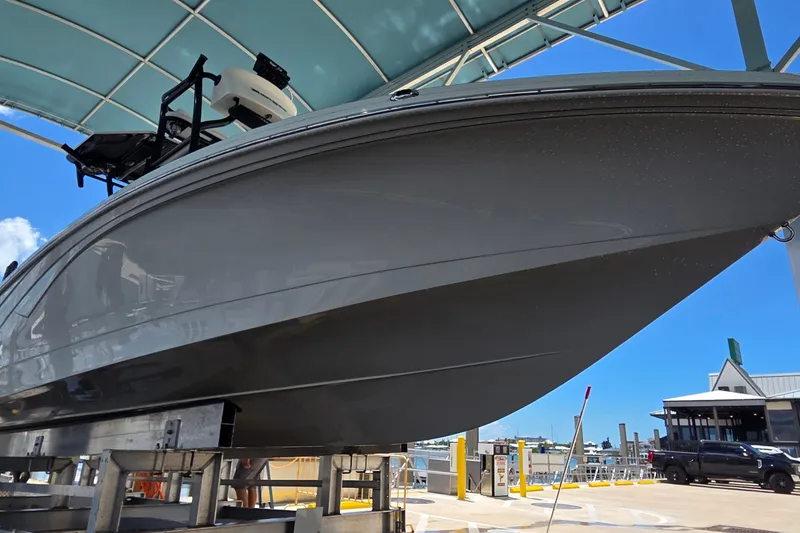 Slide: The Image of 2016 Ranger 2510 Bay Ranger boat under a canopy at a marina. - 51